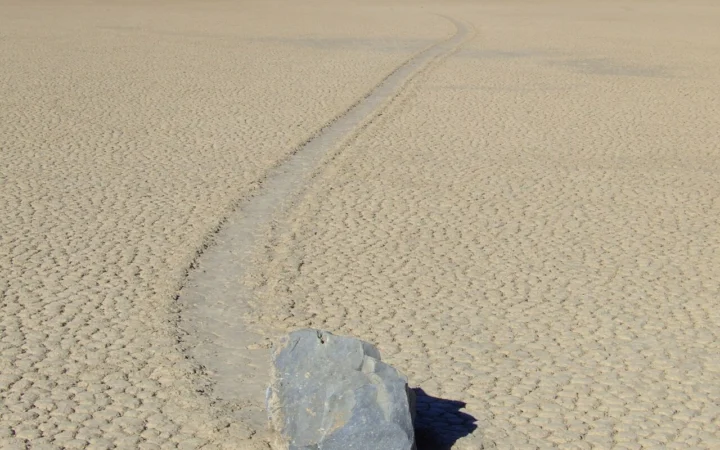 A sailing stone and its trail on the cracked ground of Racetrack Playa.