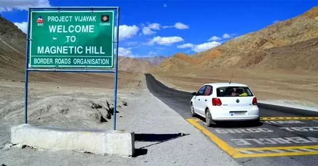 Road at a Magnetic Hill attraction with an apparent slope