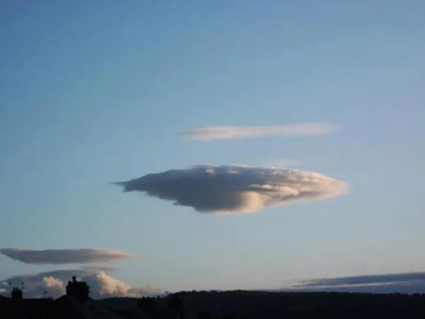 Smooth lens-shaped cloud against the evening sky