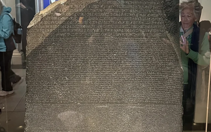 The Rosetta Stone photographed at the British Museum, showing the surviving inscription and broken upper edge