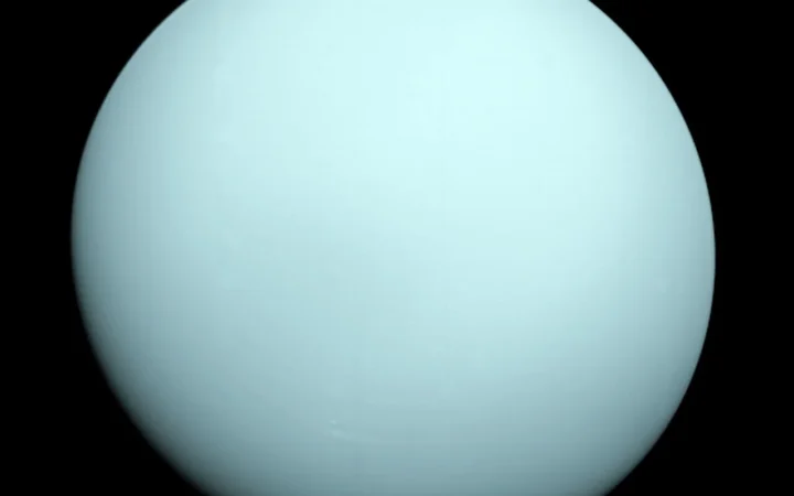 Voyager 2 view of the blue-green disk of Uranus.