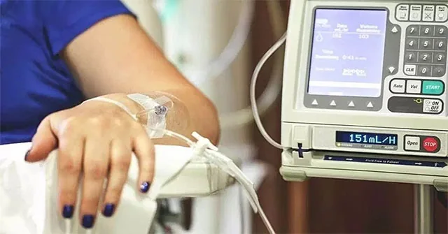 Medical infusion equipment beside a patient's arm