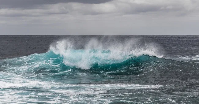 Breaking ocean waves along a coast