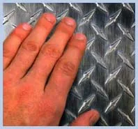 Hand touching a metal surface