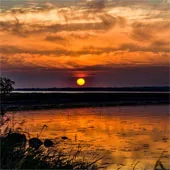 Red and orange sunset above water
